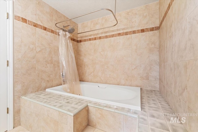 full bath featuring tiled shower / bath