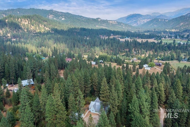 aerial view with a wooded view and a mountain view