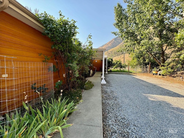 view of side of property featuring a garage and a mountain view