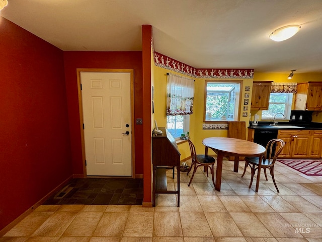 dining area with light tile patterned flooring and sink