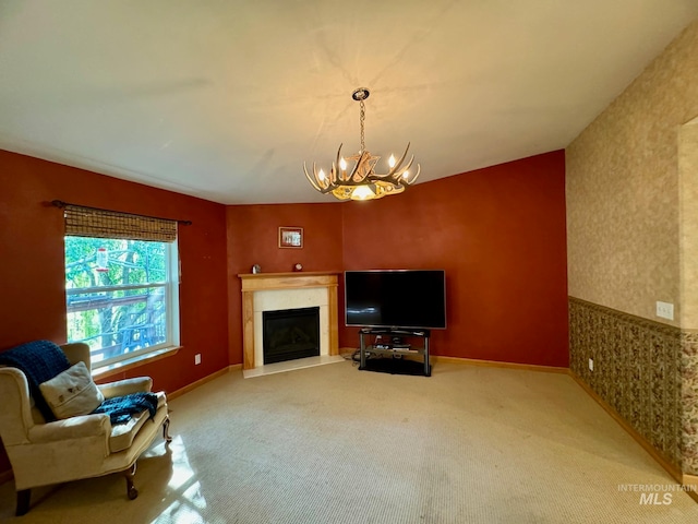 carpeted living room featuring a fireplace and an inviting chandelier