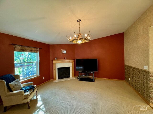 384 Race Creek Rd, Riggins, ID 83549 - living area with a fireplace, an inviting chandelier, carpet, and wallpapered walls