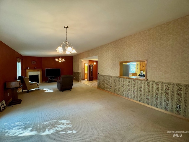 384 Race Creek Rd, Riggins, ID 83549 - unfurnished living room featuring carpet flooring, a notable chandelier, and wallpapered walls