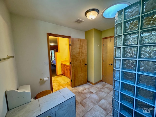 bathroom with tile patterned floors and vanity