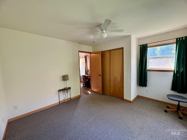 unfurnished bedroom with ceiling fan, a closet, and carpet floors