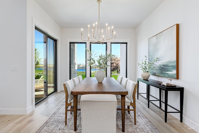 6203 W Estuary St, Eagle, ID 83616 - dining room with healthy amount of natural light, a chandelier, light wood-type flooring, and baseboards