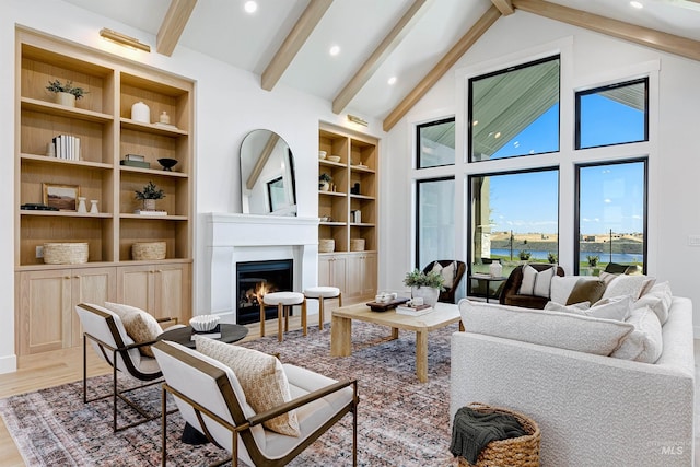 6203 W Estuary St, Eagle, ID 83616 - living room with a warm lit fireplace, wood finished floors, beam ceiling, recessed lighting, and built in features