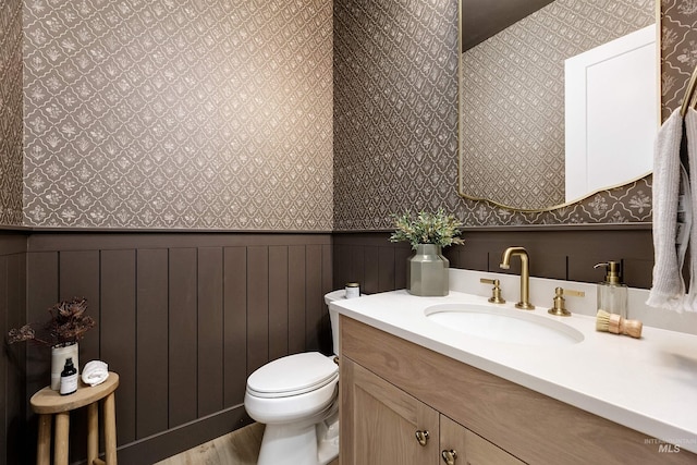 6203 W Estuary St, Eagle, ID 83616 - half bath with wallpapered walls, vanity, wainscoting, toilet, and wood finished floors
