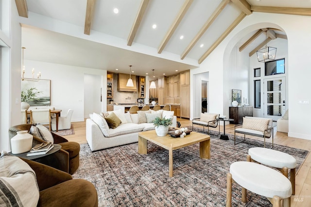 6203 W Estuary St, Eagle, ID 83616 - living area with a chandelier, light wood-style flooring, high vaulted ceiling, beam ceiling, and arched walkways