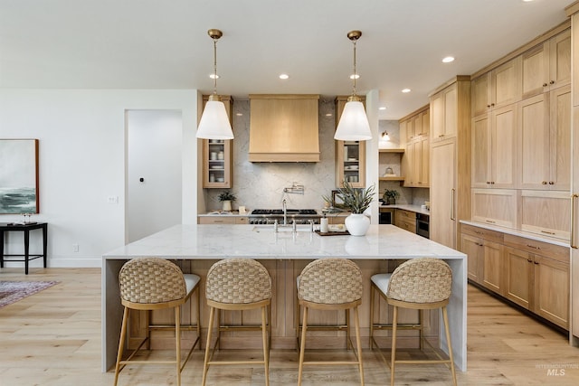 6203 W Estuary St, Eagle, ID 83616 - kitchen with custom exhaust hood, light wood-type flooring, light stone countertops, decorative backsplash, and recessed lighting