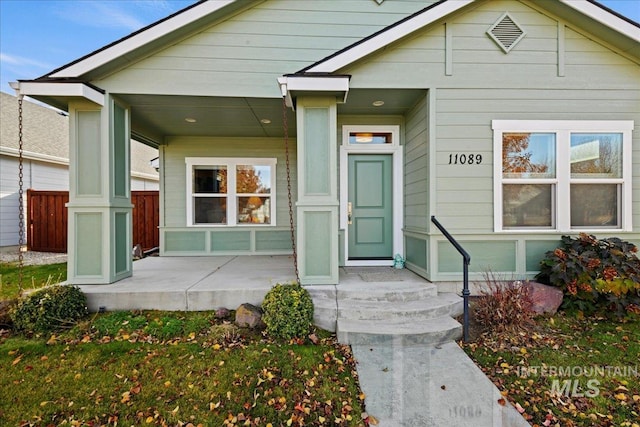 view of exterior entry with a porch