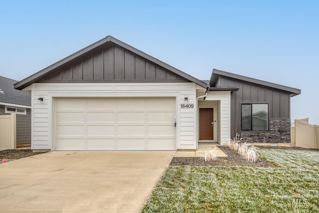 single story home featuring driveway, stone siding, fence, board and batten siding, and a garage