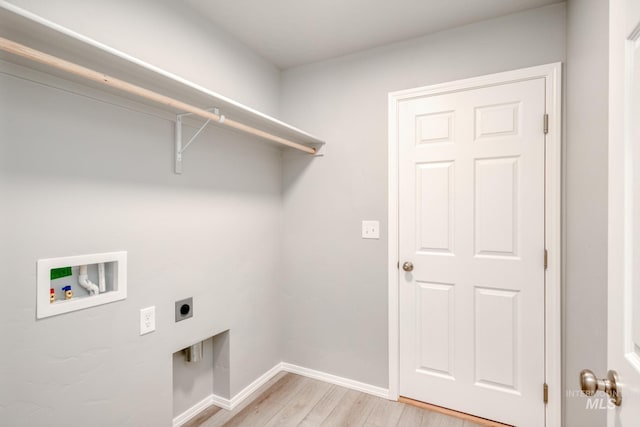 laundry area with light wood finished floors, baseboards, washer hookup, laundry area, and electric dryer hookup