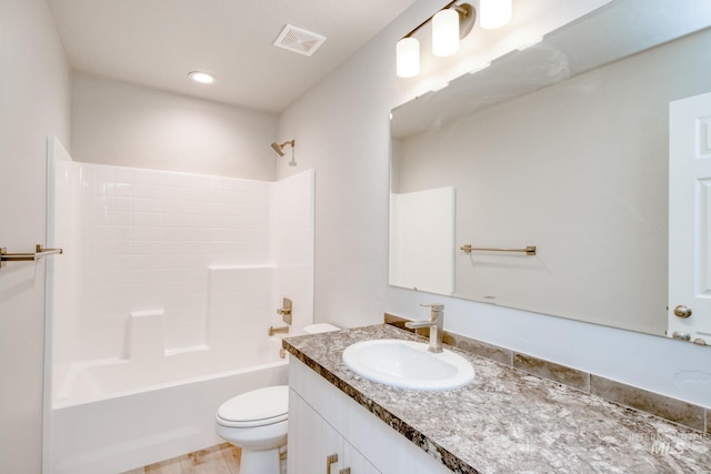 bathroom with visible vents, toilet, vanity, and bathing tub / shower combination