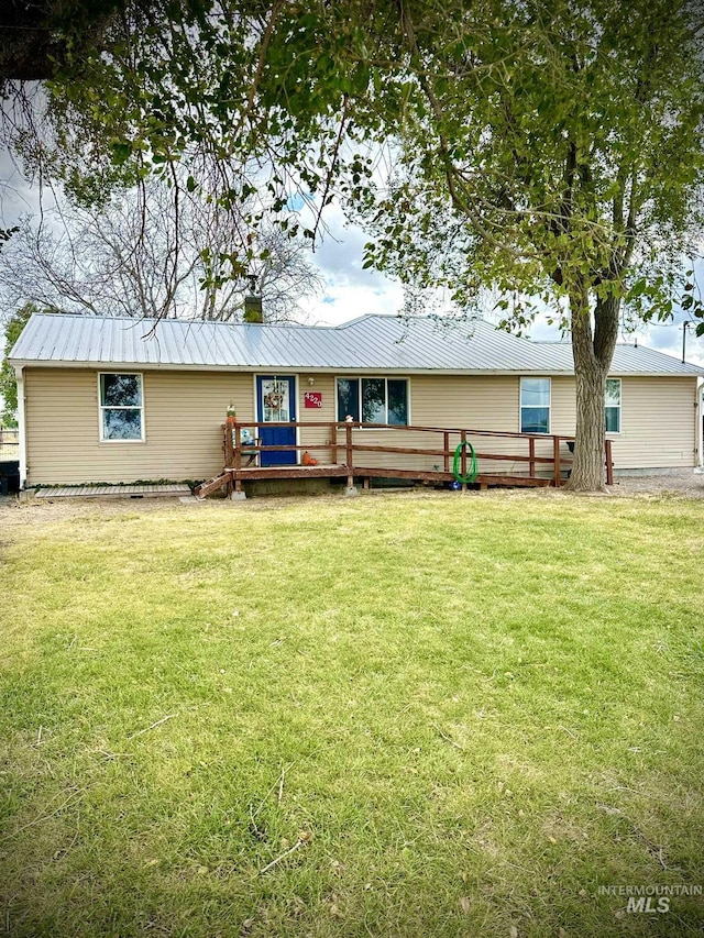 4220NORTH 1360 1360 E E, Buhl, ID 83316 - view of front of home with a deck, metal roof, and a front lawn