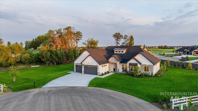 8848 Overunder Ln, Middleton, ID 83644 - view of front of house with stone siding, a garage, and concrete driveway