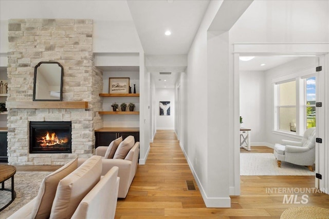 8848 Overunder Ln, Middleton, ID 83644 - living room featuring light wood finished floors, a fireplace, baseboards, and recessed lighting