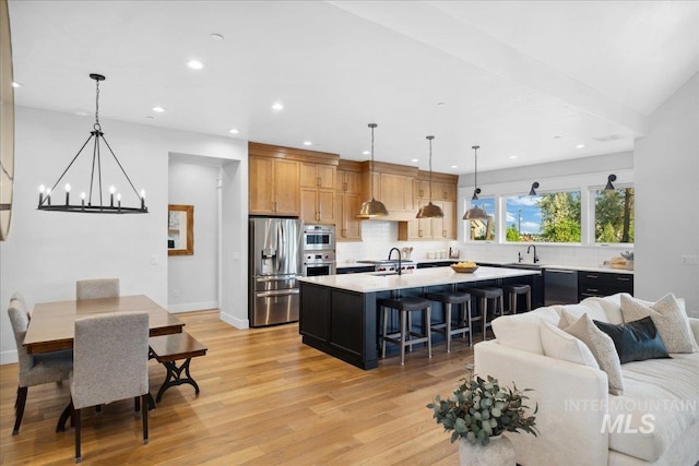 8848 Overunder Ln, Middleton, ID 83644 - living room with light wood finished floors, a chandelier, recessed lighting, and baseboards