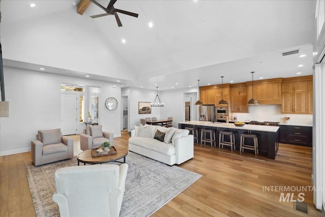 8848 Overunder Ln, Middleton, ID 83644 - living area featuring high vaulted ceiling, ceiling fan, light wood-style flooring, recessed lighting, and beam ceiling