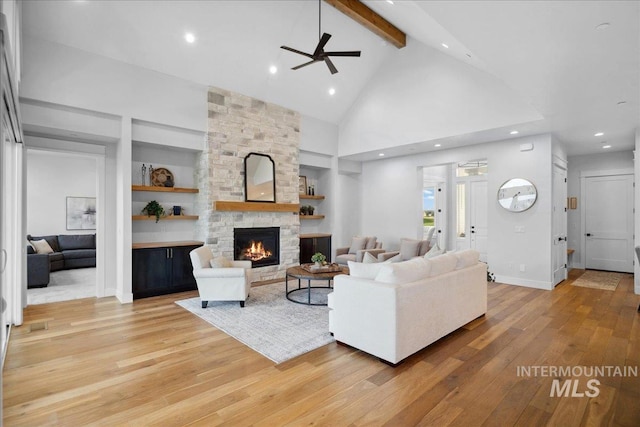 8848 Overunder Ln, Middleton, ID 83644 - living room with ceiling fan, light wood-type flooring, high vaulted ceiling, beam ceiling, and a stone fireplace