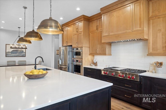 8848 Overunder Ln, Middleton, ID 83644 - kitchen featuring stainless steel appliances, a sink, light countertops, decorative backsplash, and pendant lighting