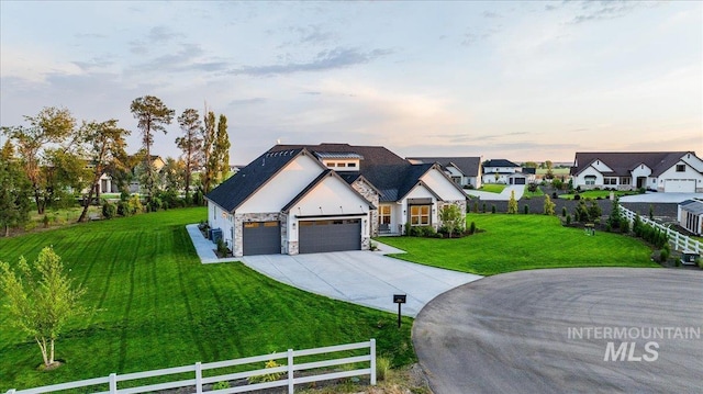 8848 Overunder Ln, Middleton, ID 83644 - view of front of home featuring stone siding, concrete driveway, an attached garage, a residential view, and stucco siding