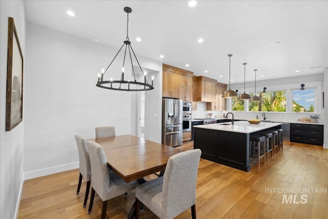 8848 Overunder Ln, Middleton, ID 83644 - dining room featuring light wood-style floors, a chandelier, recessed lighting, and baseboards