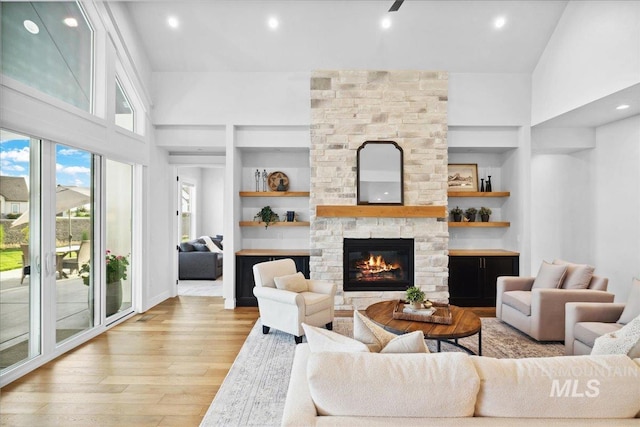 8848 Overunder Ln, Middleton, ID 83644 - living room with built in features, light wood-type flooring, a fireplace, and recessed lighting