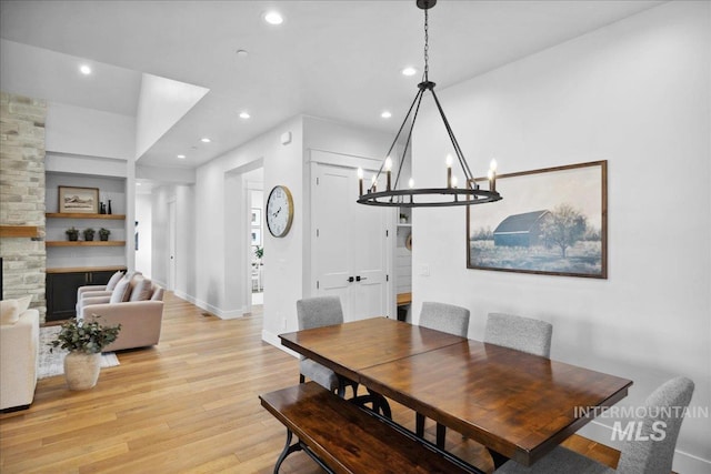 8848 Overunder Ln, Middleton, ID 83644 - dining area with light wood-style floors, recessed lighting, a chandelier, a stone fireplace, and baseboards