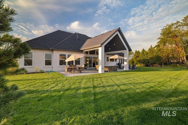 8848 Overunder Ln, Middleton, ID 83644 - back of property with a patio area, a lawn, roof with shingles, and stucco siding