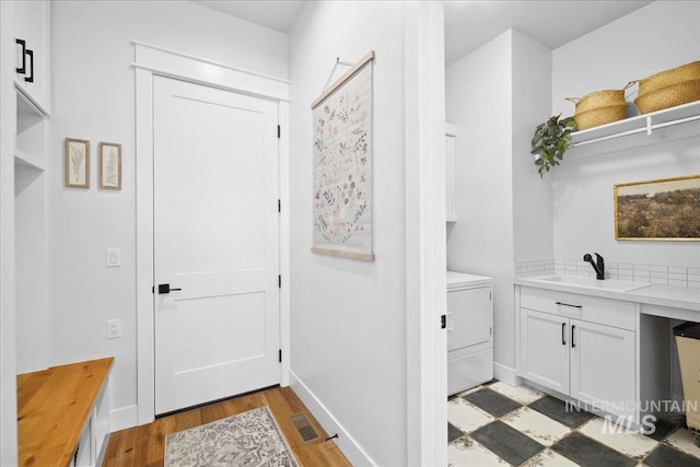 8848 Overunder Ln, Middleton, ID 83644 - mudroom with washer / clothes dryer, light wood-style flooring, baseboards, and a sink