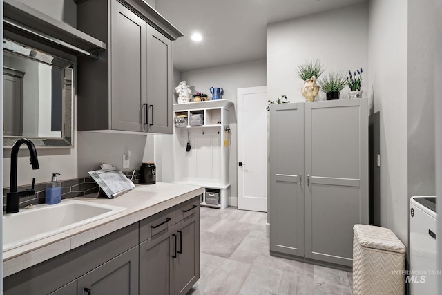 kitchen featuring recessed lighting, a sink, light countertops, gray cabinets, and open shelves