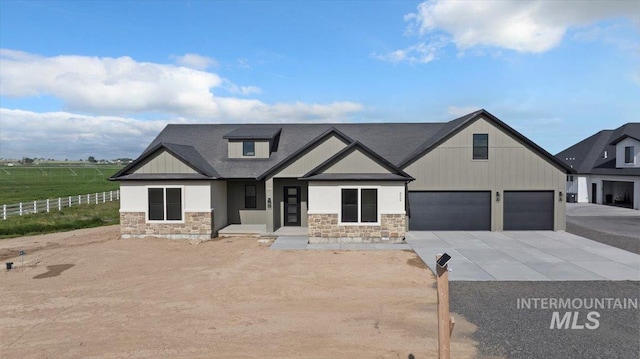 4069N 2200 2200 E E, Filer, ID 83328 - view of front of house with stone siding, driveway, and an attached garage