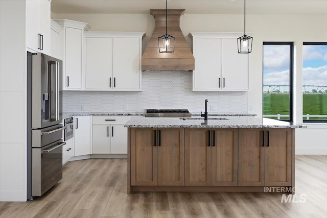 4069N 2200 2200 E E, Filer, ID 83328 - kitchen featuring high quality fridge, custom range hood, stove, light wood-type flooring, and a sink