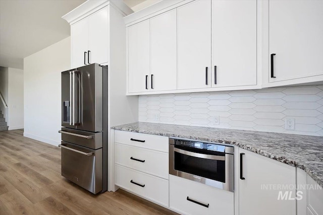 4069N 2200 2200 E E, Filer, ID 83328 - kitchen with appliances with stainless steel finishes, white cabinetry, and light stone counters