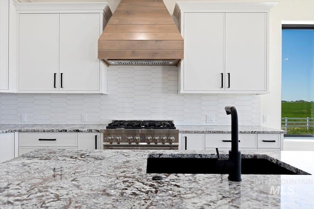 4069N 2200 2200 E E, Filer, ID 83328 - kitchen with premium range hood, stainless steel range, white cabinetry, and light stone counters