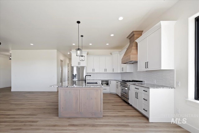 4069N 2200 2200 E E, Filer, ID 83328 - kitchen featuring stainless steel appliances, a sink, light stone countertops, an island with sink, and recessed lighting