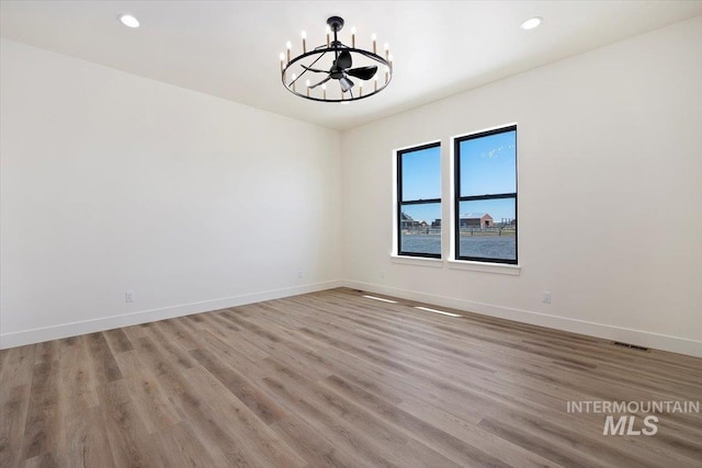 4069N 2200 2200 E E, Filer, ID 83328 - unfurnished room with a chandelier, wood finished floors, baseboards, and recessed lighting