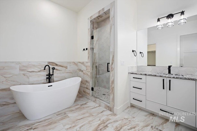 4069N 2200 2200 E E, Filer, ID 83328 - full bathroom with marble look tiles, a stall shower, a freestanding bath, vanity, and wainscoting