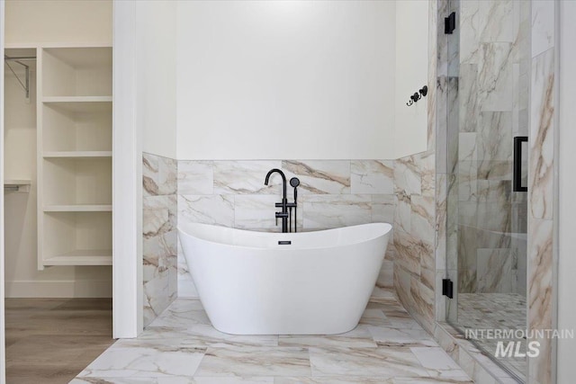 4069N 2200 2200 E E, Filer, ID 83328 - bathroom with a soaking tub, a walk in closet, a marble finish shower, tile walls, and marble tiled floors