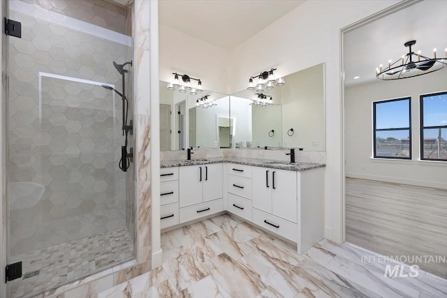 4069N 2200 2200 E E, Filer, ID 83328 - bathroom featuring double vanity, a stall shower, a chandelier, and baseboards