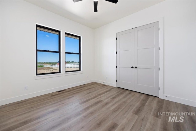 4069N 2200 2200 E E, Filer, ID 83328 - unfurnished bedroom with wood finished floors, baseboards, a ceiling fan, and a closet