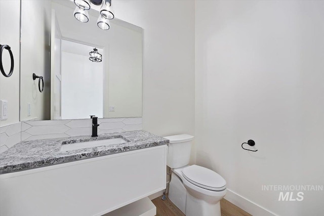 4069N 2200 2200 E E, Filer, ID 83328 - bathroom with vanity, toilet, baseboards, and wood finished floors