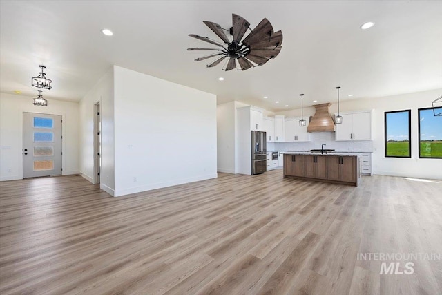 4069N 2200 2200 E E, Filer, ID 83328 - kitchen with open floor plan, high quality fridge, custom exhaust hood, recessed lighting, and light wood finished floors