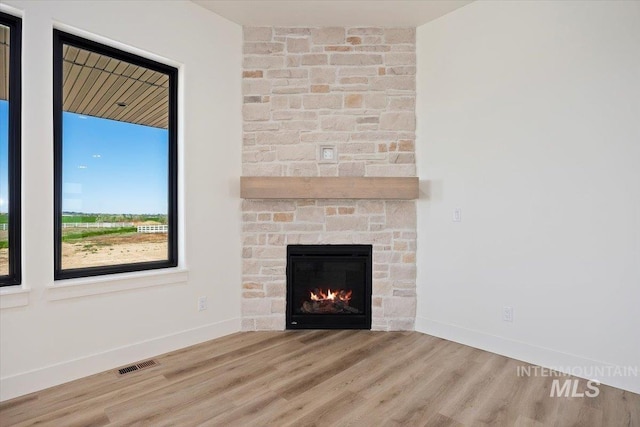 4069N 2200 2200 E E, Filer, ID 83328 - unfurnished living room with wood finished floors, baseboards, and a fireplace
