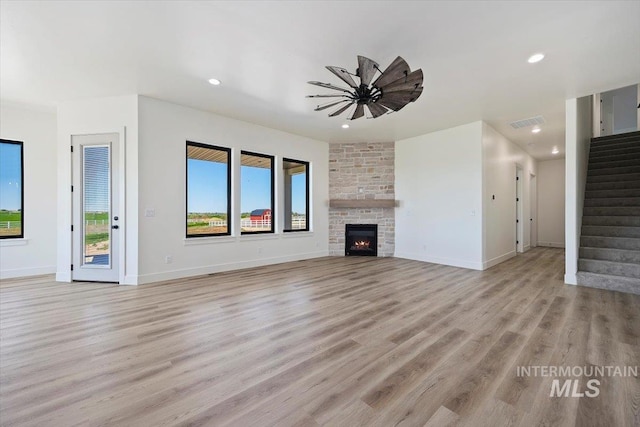 4069N 2200 2200 E E, Filer, ID 83328 - unfurnished living room with light wood finished floors, stairway, recessed lighting, baseboards, and ceiling fan