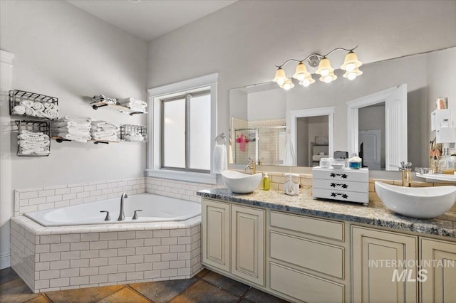 bathroom featuring vanity, independent shower and bath, and tile patterned flooring