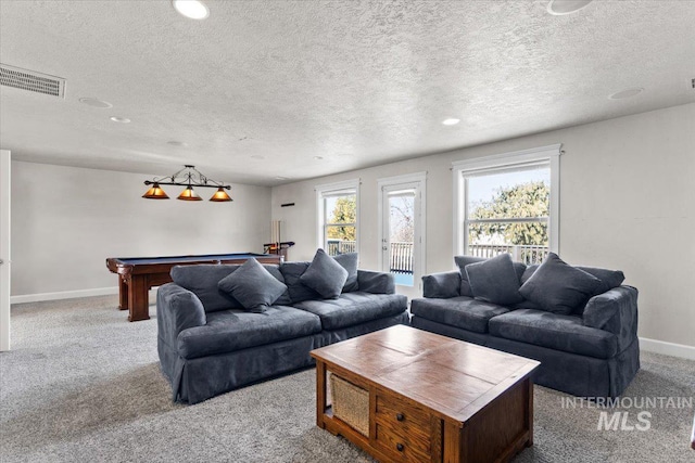 carpeted living room with pool table and a textured ceiling