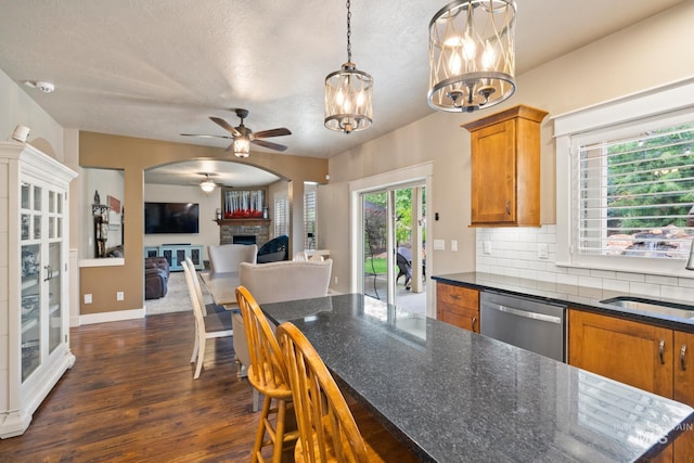 9462 W Whitecrest, Star, ID 83669 - kitchen with dishwasher, brown cabinetry, ceiling fan, a chandelier, and dark wood-type flooring