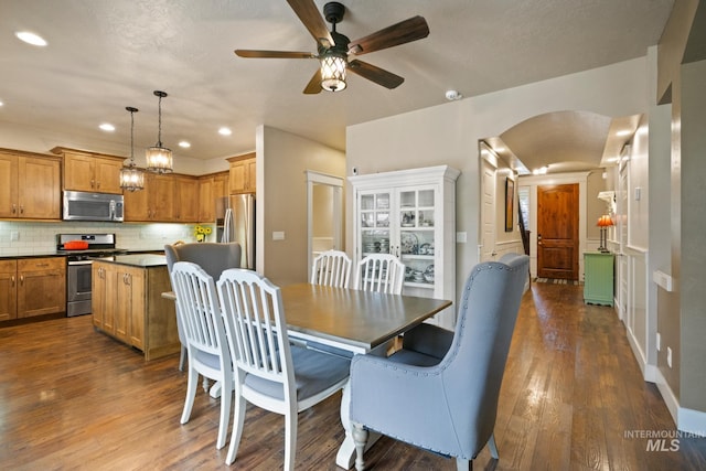 9462 W Whitecrest, Star, ID 83669 - dining area with dark wood-style floors, recessed lighting, a ceiling fan, and arched walkways